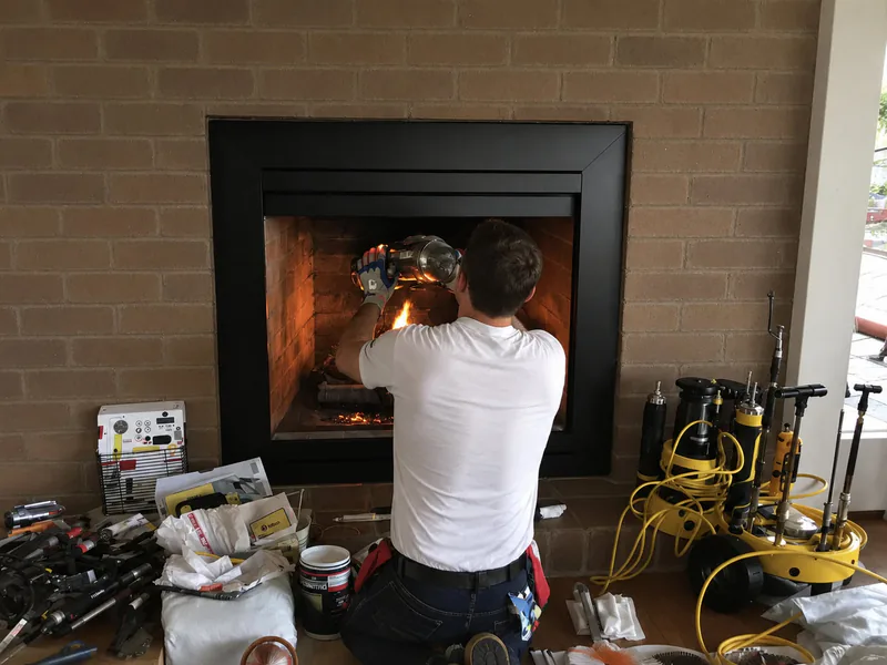 Stainless flue liner section being fitted into a masonry chimney